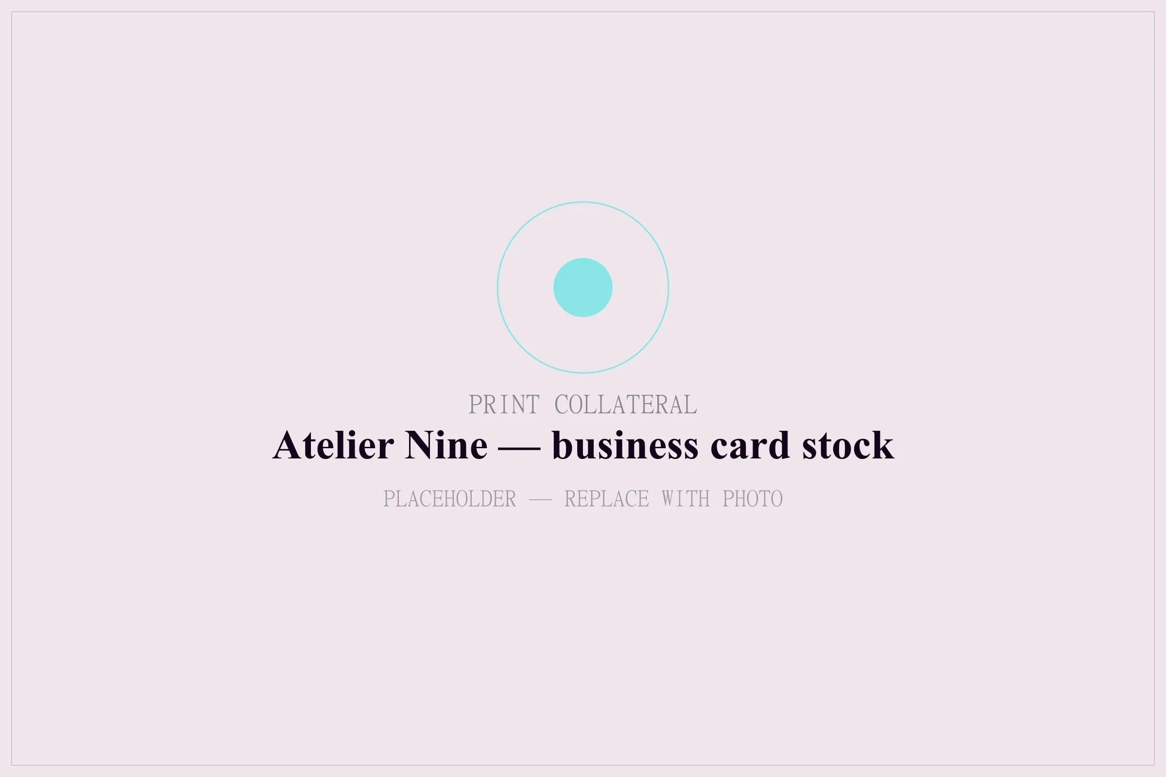 Close view of a business card edge showing the duplexed stock and the blind-deboss logo.