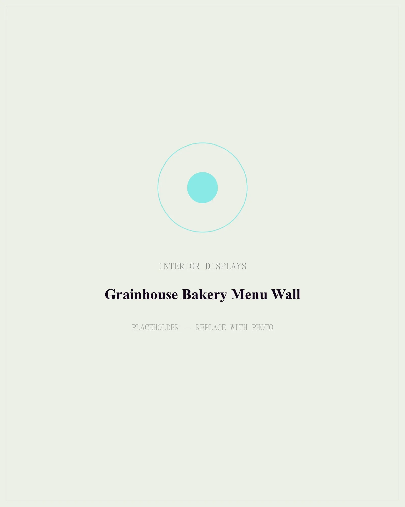 A bakery's back wall covered in a warm oak-framed menu board with painted-look lettering and swappable price strips.